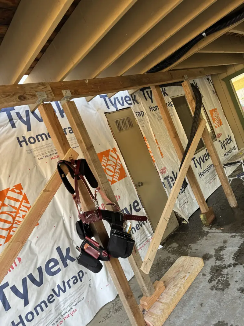 New wall framing wrapped in house wrap