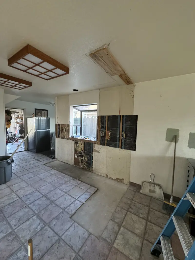 Kitchen and dining area opened up during a remodel, with old cabinets and soffits removed